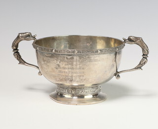 A silver Arts and Crafts style 2 handled bowl with mythical beast handles and strap work decoration Birmingham 1913, 217 grams 16cm