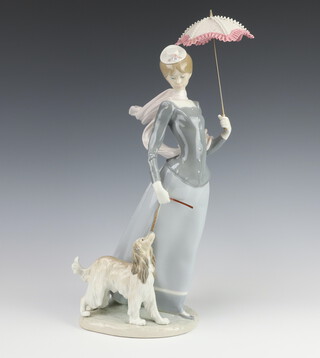 A Lladro figure of a standing lady with parasol and dog 43cm h, base impressed D-14A 
