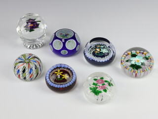 Four John Deacons and William Mason limited edition paperweights - 1 with daffodils to the centre base marked 529 5/25, a double overlay paperweight with floral decoration base with label, a floral patterned paperweight base marked 23 and with label and ditto with flower head to the centre base with paper label, together with 3 other John Deacons paperweights (unlabelled to bases) 

