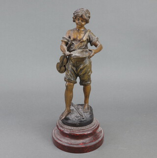 A spelter figure of a young boy holding a bowl 30cm 