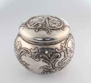 A Victorian circular repousse silver trinket box decorated with cavorting cherubs import marks for London 1898, 88 grams, 6.5cm 