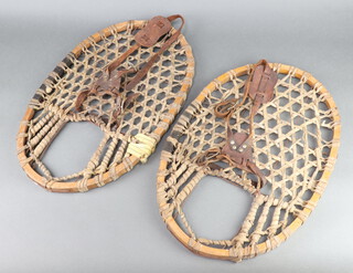 A pair of 1930's wooden and hide snowshoes 50cm x 34cm 