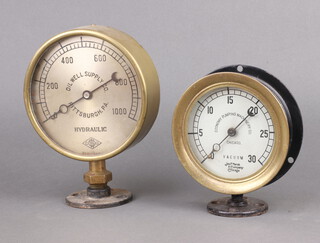 Oil Well Supply Company, a circular steel and brass pressure gauge marked Oil Supply Company Pitsburgh.PA, Hydraulic 23cm h x 4cm, together with 1 other marked Economy Plumbing Manufacturing Company Chicago Vacuum 17cm h x 4cm 