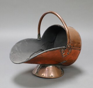 A Victorian copper helmet shaped coal scuttle raised on a circular base 33cm x 41cm x 28cm 