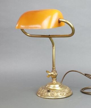 A reproduction brass bank lamp with amber glass shade, on a gilt metal base 40cm x 34cm 