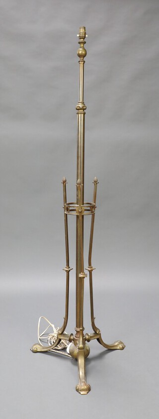 An Art Nouveau adjustable brass standard lamp with pineapple finial, raised on outswept supports 35cm x 41cm 