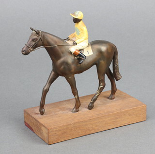 A spelter figure of a race horse with jockey up on a wooden base 14cm x 12cm x 6cm 