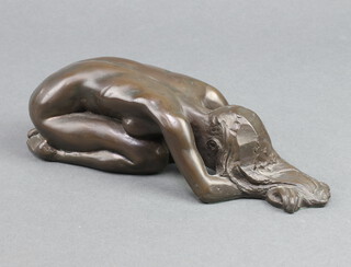 A bronzed figure of a crouching naked lady 6cm x 20cm x 5cm 