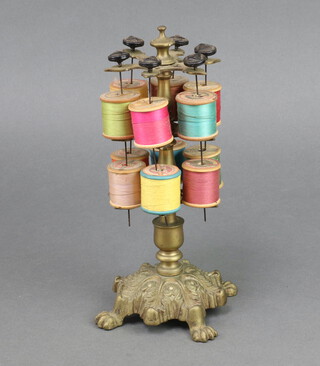 A Victorian style gilt metal 2 tier cotton reel stand, raised on a circular leaf shaped base 24cm x 13cm 