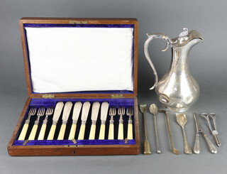 An Edwardian silver plated engraved ewer, a cased set of fish eaters a plated cheese scoop, grape scissors, stirrer, glove stretcher and two brass tools  