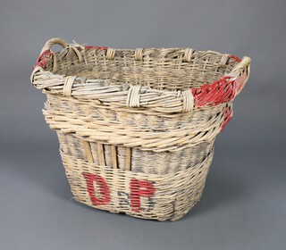 A large oval wicker 3 handled basket marked DAP 70cm h x 89cm w x 71cm  