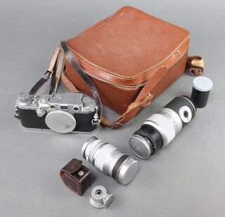 A Leica DRP Rangefinder camera by Ernst Wetzlar No 2483310 with lenses Leica Elmar f/9 1:4, Leica Summitar f/5 1:2 and a Leica Hektor f/13.5 1:4,5 and two Leica finders 9cm and 13.5, complete with fitted West German leather carry case. 