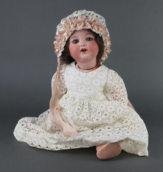 Armand Marseille, a porcelain headed doll with sleep eyes, open mouth with 2 teeth and articulated body, the head incised AM Koppelsdorf Germany 996 A9M, 52cm  