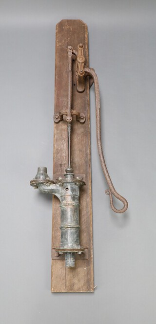A 19th Century iron water pump on oak backing 176cm x 22cm 