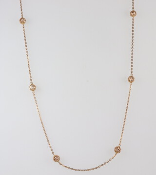 A 9ct yellow gold necklace with pierced ball spacers, 10.6 grams, 64 cm 
