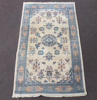 A 1930's blue and white ground Chinese rug with central medallion 212cm x 125cm 
