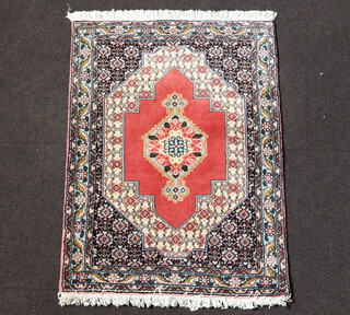 A pink, cream and white ground Persian rug with central medallion within multi row border 99cm x 74cm 
