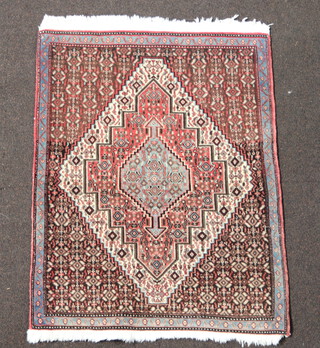 A grey, pink and blue ground Persian rug with diamond medallion to the centre 93cm x 73cm 