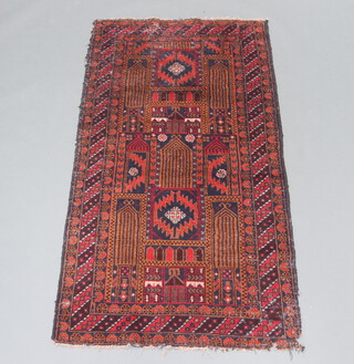 A brown and tan ground belouche rug with all over geometric designs 195cm x 104cm 