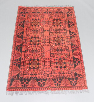 A red and black ground Afghan rug with 6 stylised medallions to the centre 196cm x 127cm 