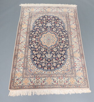 A blue and white ground Persian silk rug with central medallion within a multi row border, signed to the edge 198cm x 129cm 