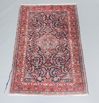A blue, white and red Persian floral patterned with central medallion 202cm x 124cm 