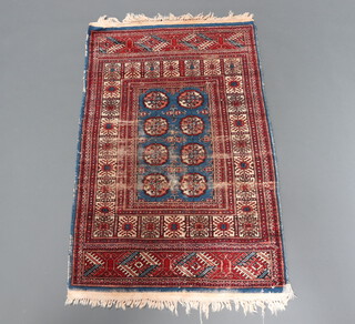 A blue and tan ground Bokhara rug with 8 octagons to the centre within multi row border 157cm x 91cm 