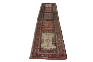 A brown and tan ground Kilim runner, the centre section formed of 5 panels with geometric designs within a multi row border 371cm x 86cm 