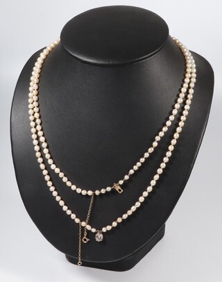 A double strand of cultured pearls, each approx. 4mm with a yellow gold old cut diamond set clasp approx. 0.5ct, 50cm 