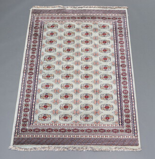 A turquoise white and brown ground Bokhara rug with 44 octagons to the centre 203cm x 136cm 