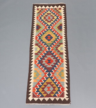 A brown and green ground Maimana Kilim runner with 4 diamonds to the centre 190cm x 62cm  