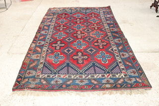 A red, white and blue ground Afghan rug with 18 stylised medallions to the centre within a multi row border 304cm x 197cm 