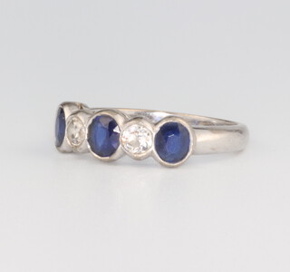 An 18ct white gold sapphire and diamond ring comprising 3 oval sapphires each approx. 0.4ct and 2 brilliant cut diamonds each approx. 0.20ct, 5.7 grams, size R 