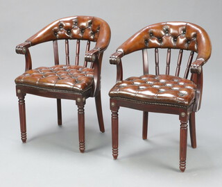 A pair of Regency style mahogany tub back chairs upholstered in brown buttoned leather, raised on turned and reeded supports 80cm h x 56cm w x 42cm d (seat 20cm x 26cm) 