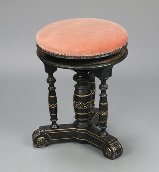 Gillow, an aesthetic movement gilt and ebonised circular revolving piano stool raised on 3 turned columns with cruciform base, impressed Gillow 10651 47cm h x 37cm diam. 