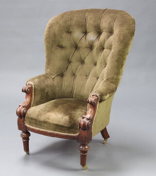 A William IV mahogany show frame armchair upholstered in green buttoned material, raised on turned supports, brass caps and casters 114cm h x 66cm w x 56cm d 
