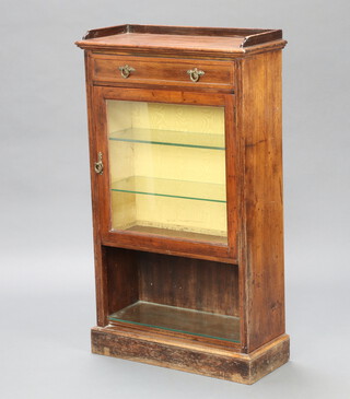 An Edwardian mahogany display cabinet with 3/4 gallery, the upper section fitted a drawer above cupboard enclosed by a glazed panelled door, the base with recess 102cm h x 65cm w x 68cm d 