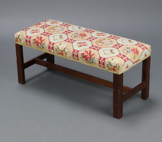 A Georgian style rectangular mahogany stool with Berlin woolwork seat raised on square supports with H framed stretcher 30cm h x 67cm w x 28cm d 