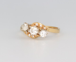 An 18ct yellow gold 3 stone diamond crossover ring, approx. 0.7ct, 3.8 grams, size O 