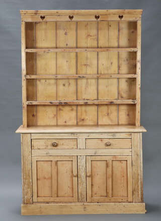 A Victorian pine dresser, the raised back fitted 3 shelves, the base fitted 3 drawers above double cupboard enclosed by panelled doors 213cm h x 135cm w x 39cm d 