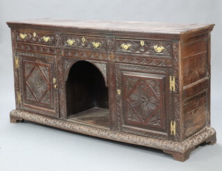 A Victorian heavily carved dark oak dog kennel dresser base, fitted 3 drawers above recess flanked by pair of cupboards with brass H framed hinges 100cm h x 195cm w x 53cm d  