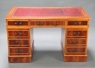A Georgian style yew kneehole desk with red inset writing surface, fitted 1 long and 8 short drawers 78cm h x 137cm w x 76cm d (contact marks in places) 