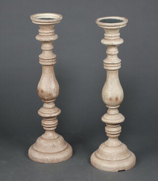 Next, a pair of oak effect resin bulbous turned torcheres/stands with mirrored tops 77cm h x 16cm diam. 