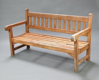 A hardwood slatted garden bench 89cm h x 153cm w x 66cm d (1 slat to seat is damaged)  