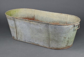 An oval galvanised twin handled bath 39cm h x 123cm l x 55cm d (some rust in places) 