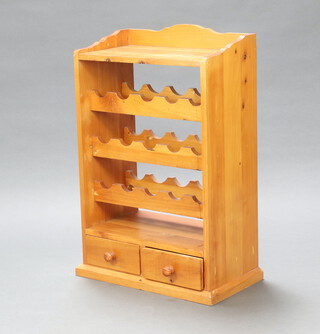 A pine 15 bottle wine rack, the back with 3/4 gallery, the base fitted 2 short drawers 84cm h x 54cm w x 30cm d 