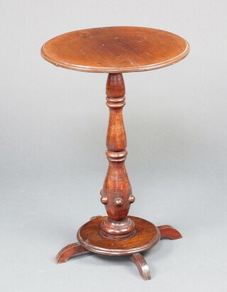 A Victorian circular mahogany wine table raised on a bulbous turned column and circular base with roundel decoration 70cm h x 46cm diam. 