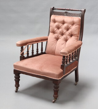 A late Victorian mahogany show frame armchair upholstered in pink material with bobbin turned decoration, raised on turned supports 96cm h x 65cm w x 65cm d 