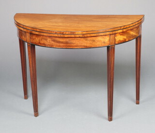 A Georgian mahogany demi-lune card table, raised on square tapered supports 73cm h x 102cm w x 50cm d 