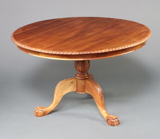 A Chippendale style circular mahogany pedestal dining table with gadrooned border, turned column and tripod base, ball and claw feet 72cm h x 118cm diam. 